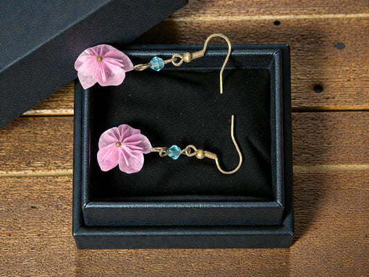 Butter Moon Creations LLc pink fabric floral dangle earrings with blue bead accents and gold hooks.