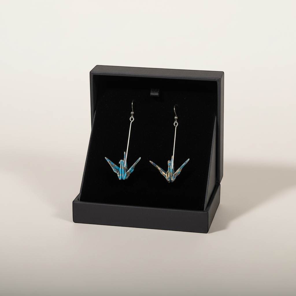 Butter Moon Creations, LLCHandmade teal & gold metallic washi paper origami crane earrings with long silver bar dangles.